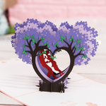 Load image into Gallery viewer, Kissing Couple on Purple Heart Wisteria Pop Up Card